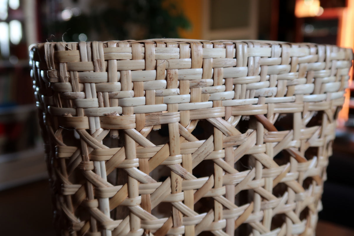 Scandi style organic wicker desktop sculpture crafted from natural bent rattan cane and woven reed webbing.