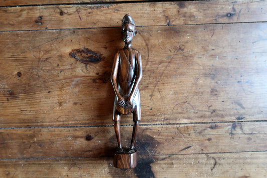 Collectible East African hand-carved wooden statue depicting a standing male figure with refined facial features.