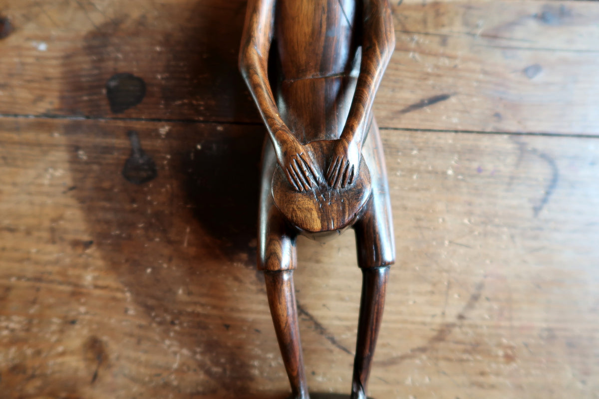 Handcrafted African hardwood carving showcasing natural wood grain texture and dark lustrous finish.