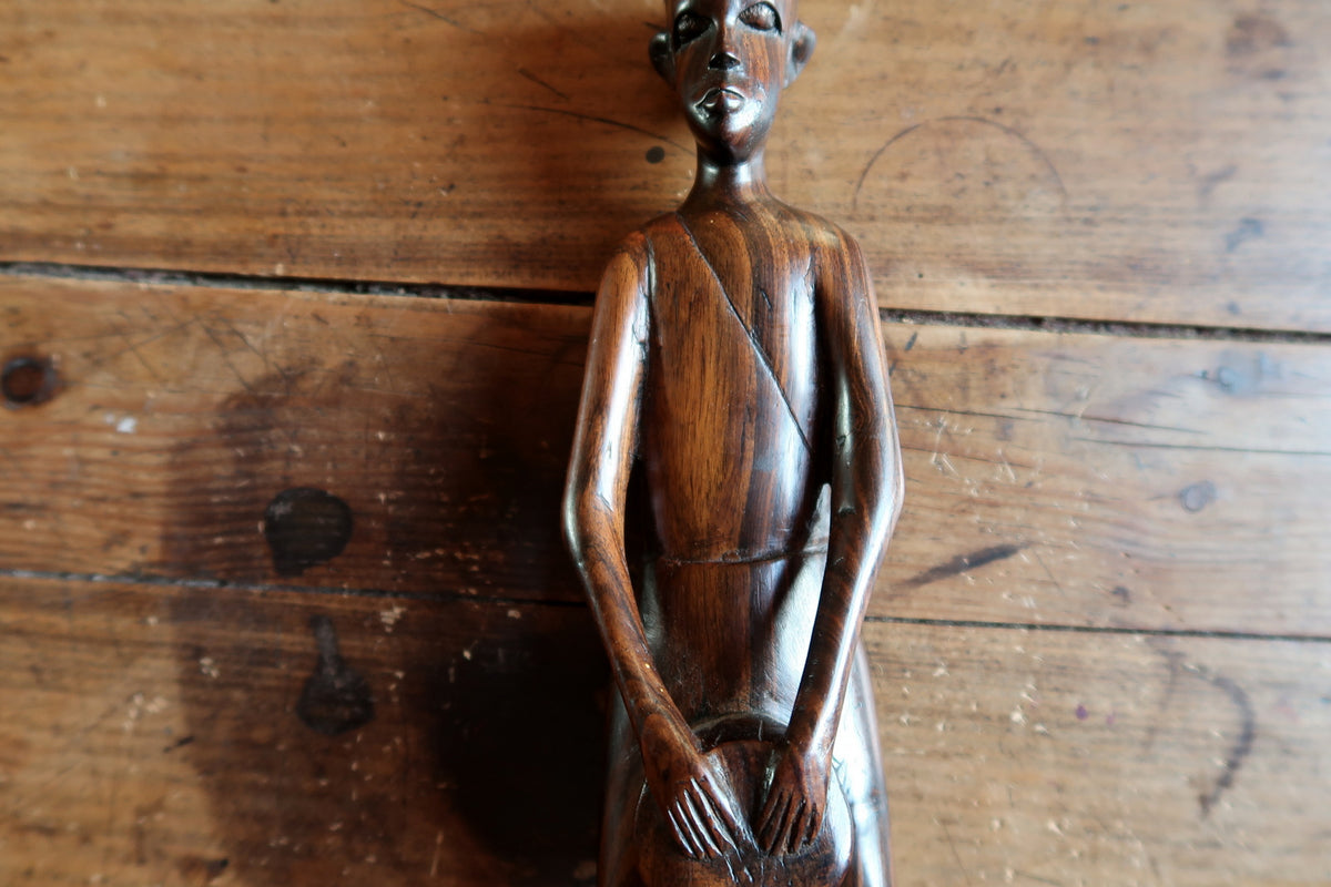 Full-length view of a mid-century East African carved wood male statue with minimalist tribal art aesthetic.