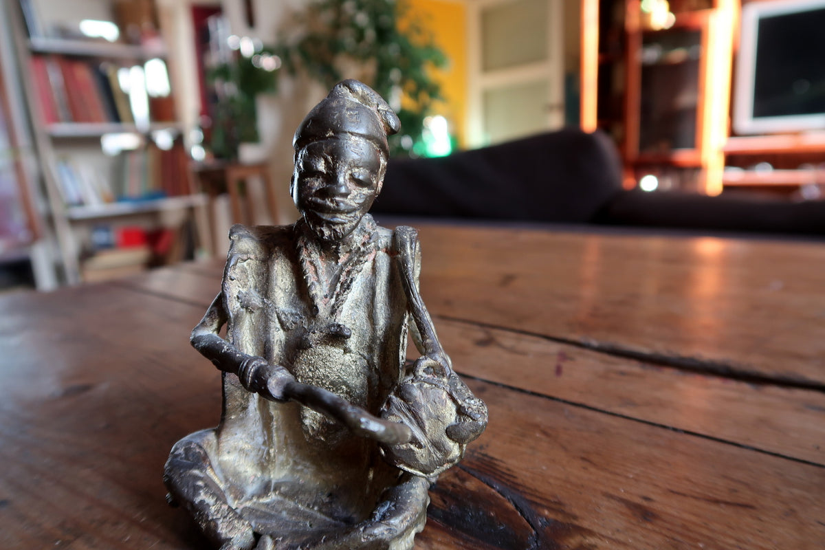Full-length view of a mid-century Dogon-style brass musician statue showcasing authentic tribal craftsmanship.