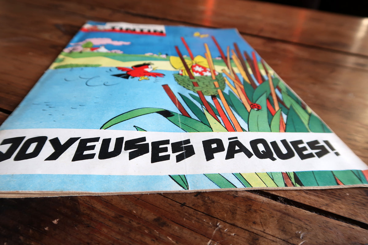 Low-angle Easter cover detail showing Joyeuses Pâques greeting, edge wear and slight curvature