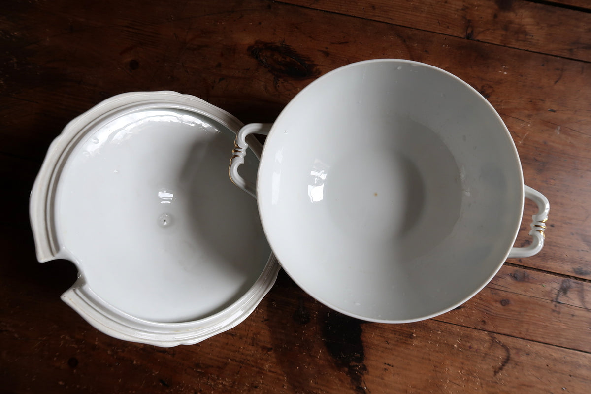 Top view of plain white bowl interior and underside of the detached lid
