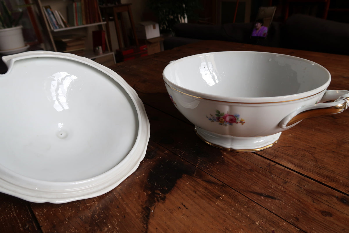 Open floral tureen beside its detached lid, showing white interior and gold-accented handle