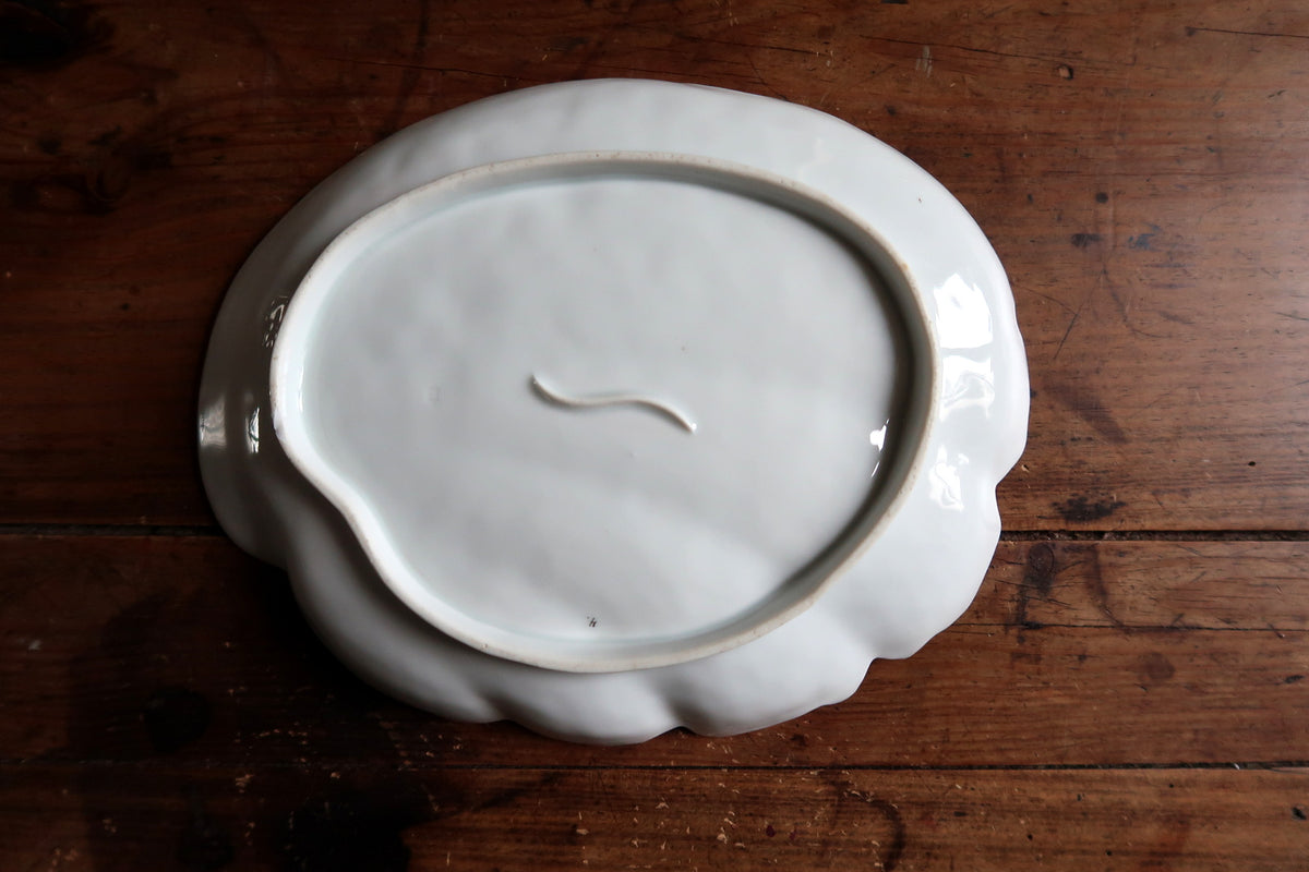 Plain underside with foot ring, central curved feature and small dark speck