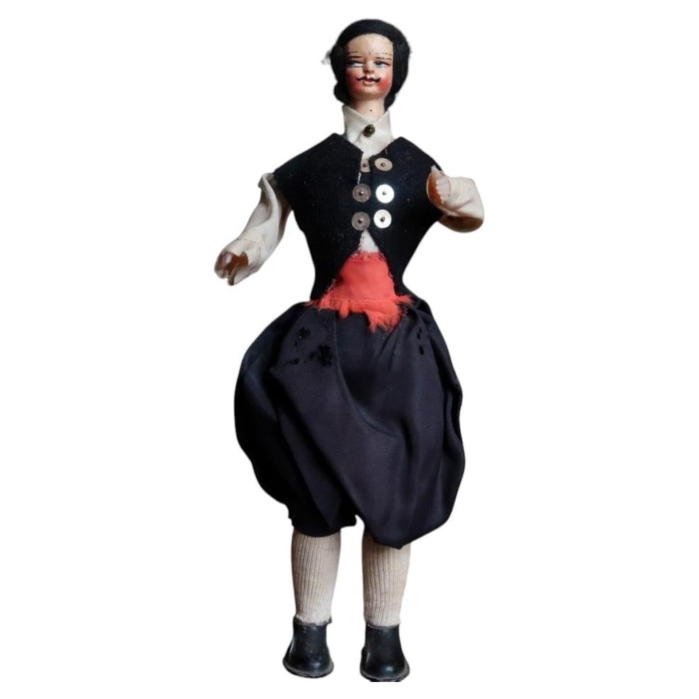 Vintage male folk costume doll 2C135 with black waistcoat and red sash