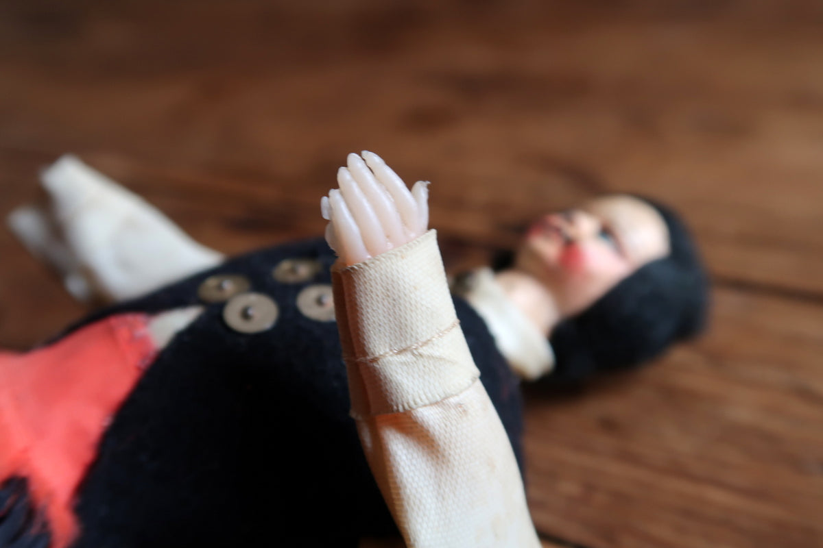 Close-up of rigid hand and frayed white cuff
