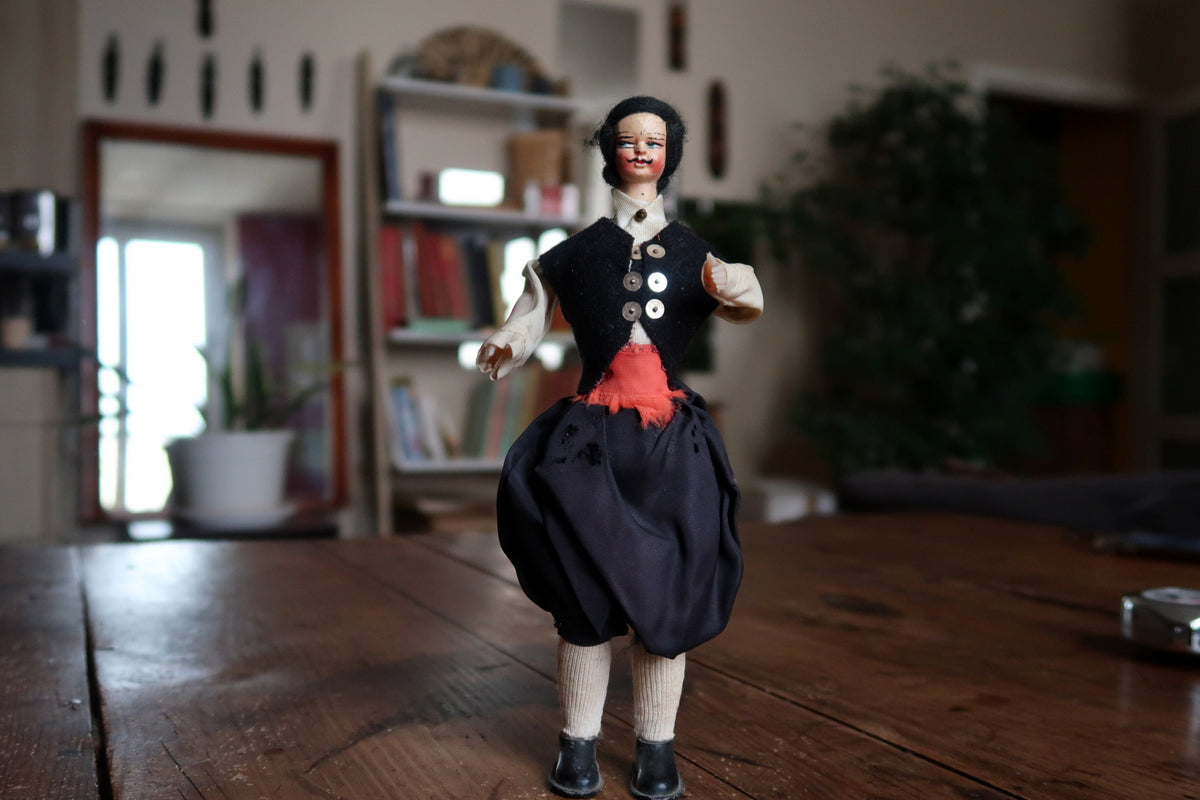 Upright doll showing the complete folk-style costume