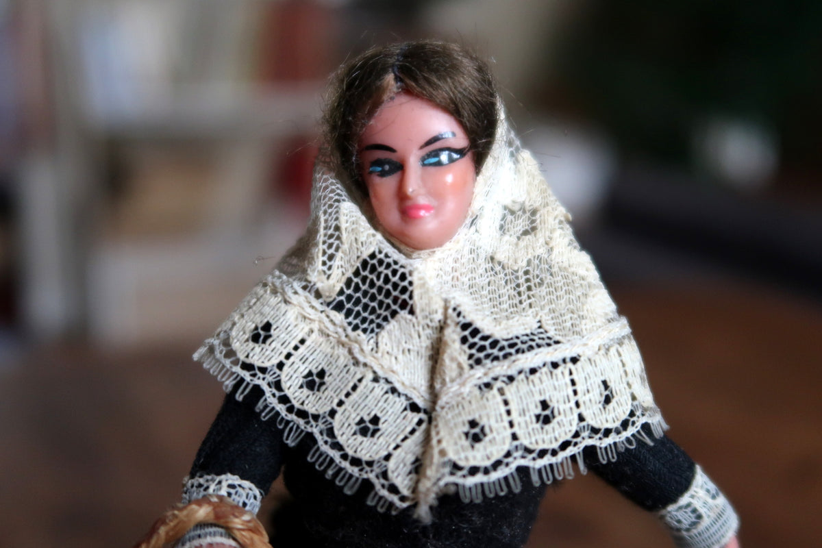 Painted face framed by white lace and brown hair