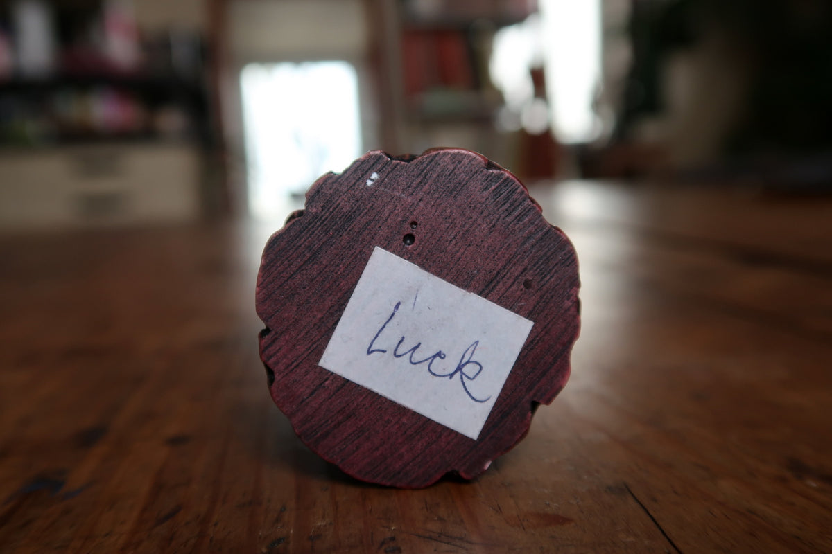 Underside with handwritten paper label reading Luck