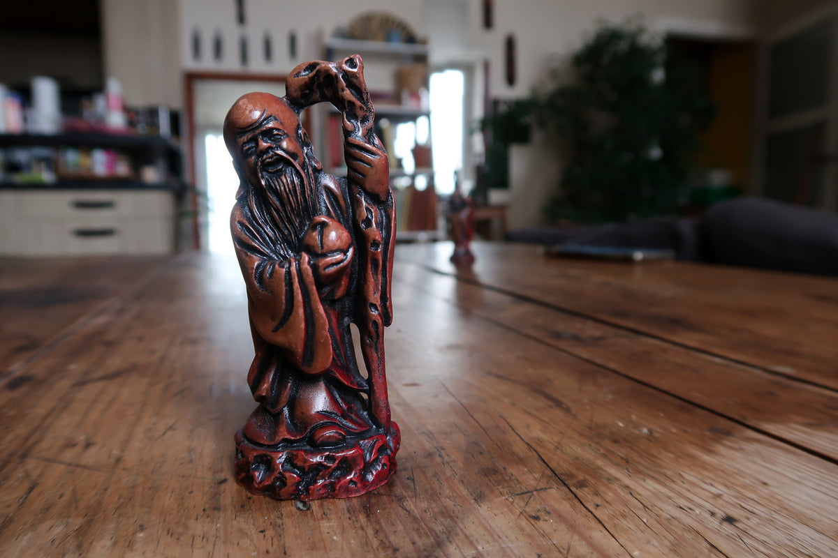 Front view of the bearded God of Longevity on a sculpted circular base