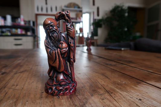 Front view of the bearded God of Longevity on a sculpted circular base