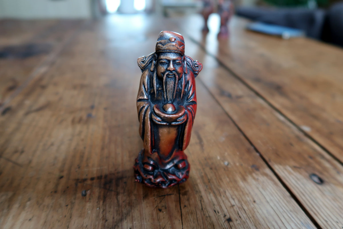 Detail of the figurine with dark accents and warm brown colouring