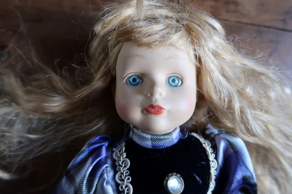 Front view showing the doll’s long blonde hair, puff sleeves and gathered skirt.
