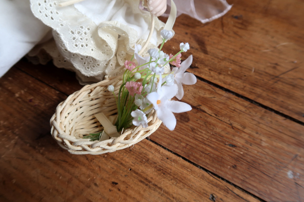 White bloomers, pale patterned stockings and cream shoes with pink ribbon bows.