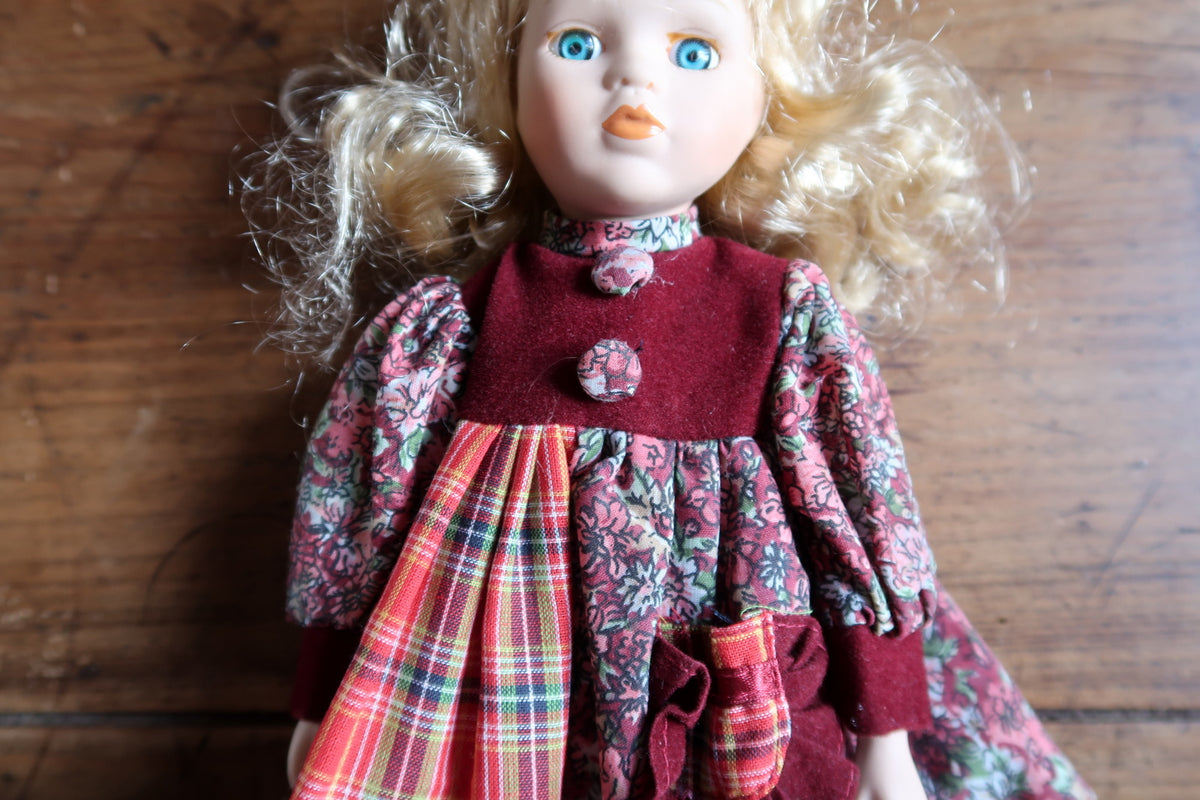 Rear hair detail showing pale blonde synthetic ringlets and flyaway fibres.