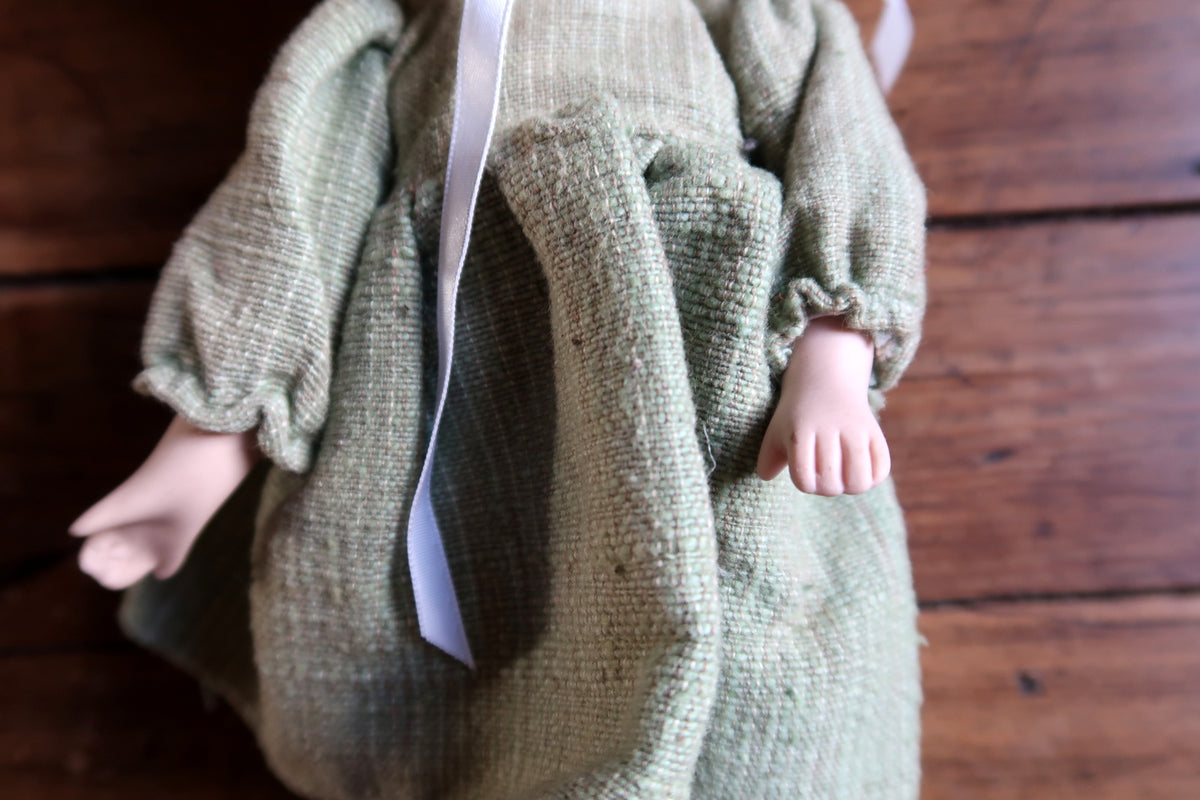 English adult collector-warning label on the back of the textured green dress.
