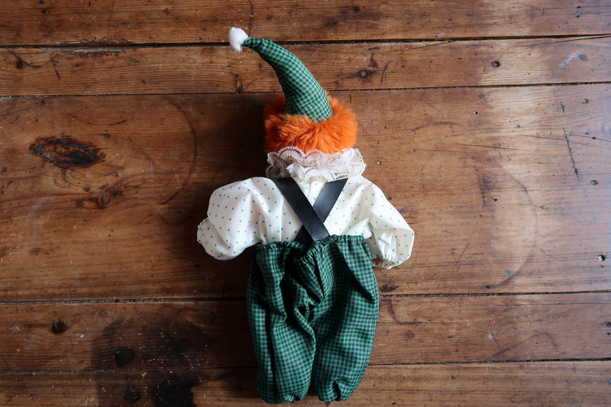 Full rear view of the fabric clown doll in a dotted shirt and green gingham trousers.