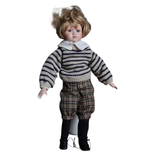 Vintage porcelain boy doll in a striped sweater, checked breeches, navy socks and black lace-up shoes.