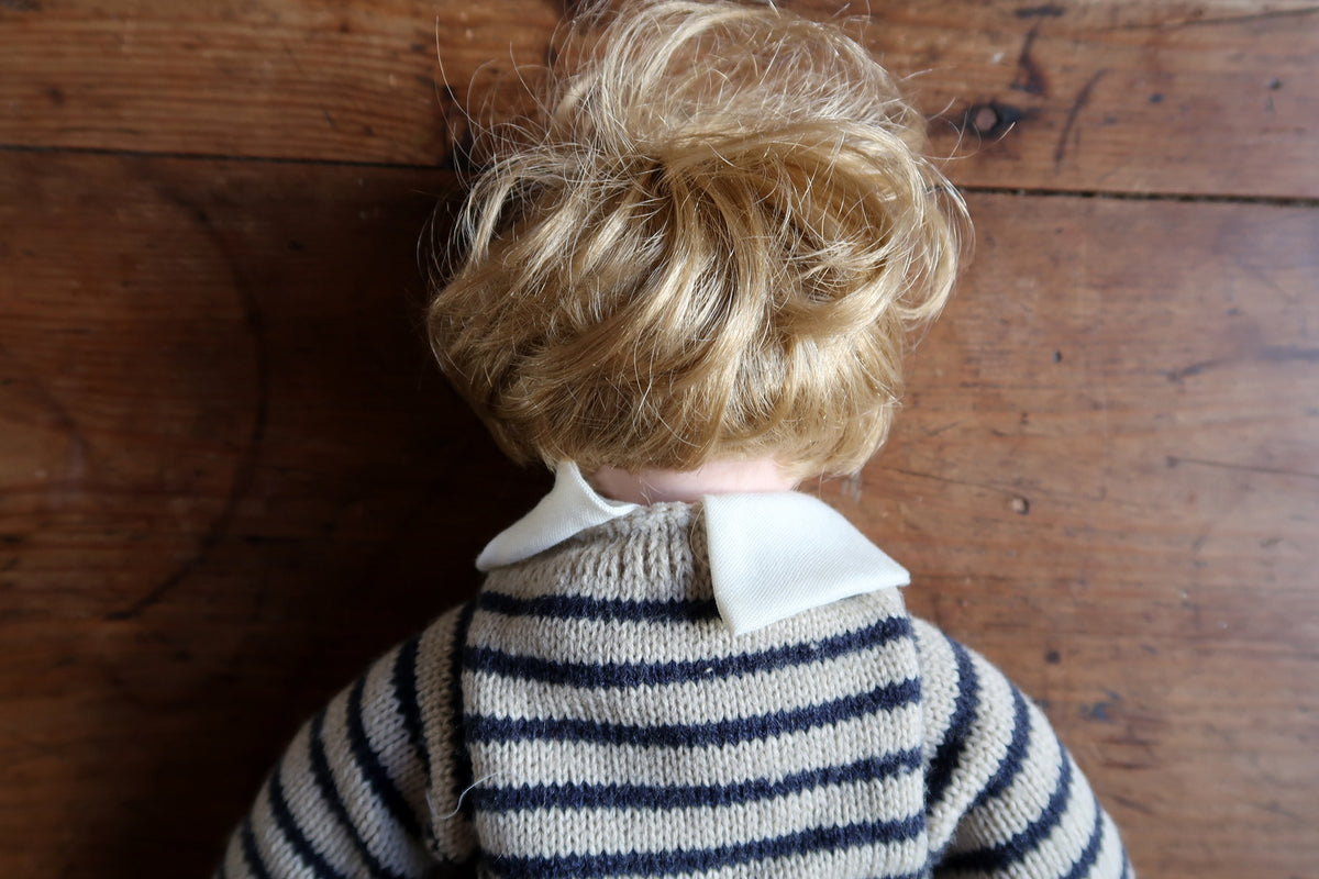 Checked breeches gathered below the knees beneath the striped sweater.