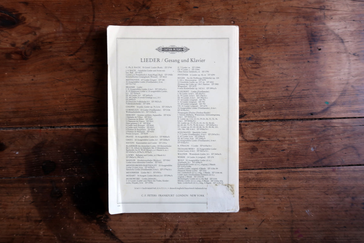 Lower binding detail showing page edges and an opening at the spine base.