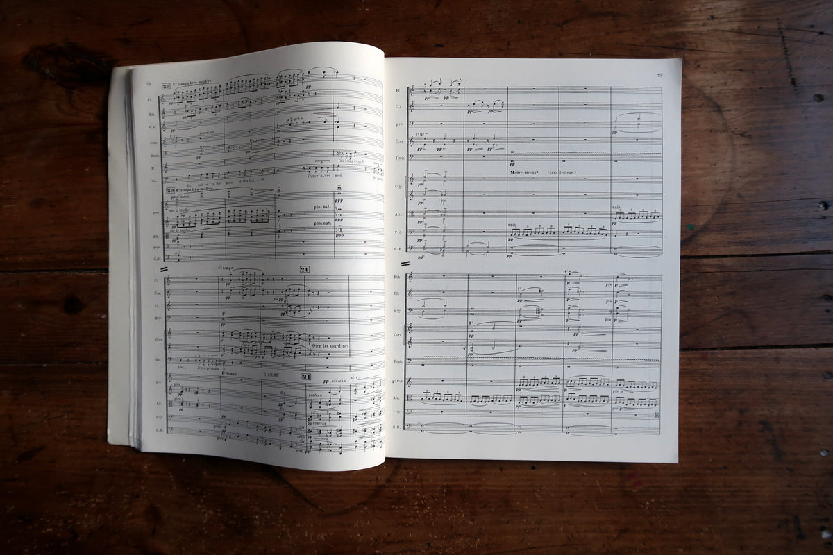 Open full-score spread showing orchestral staves, rehearsal figures and musical notation.