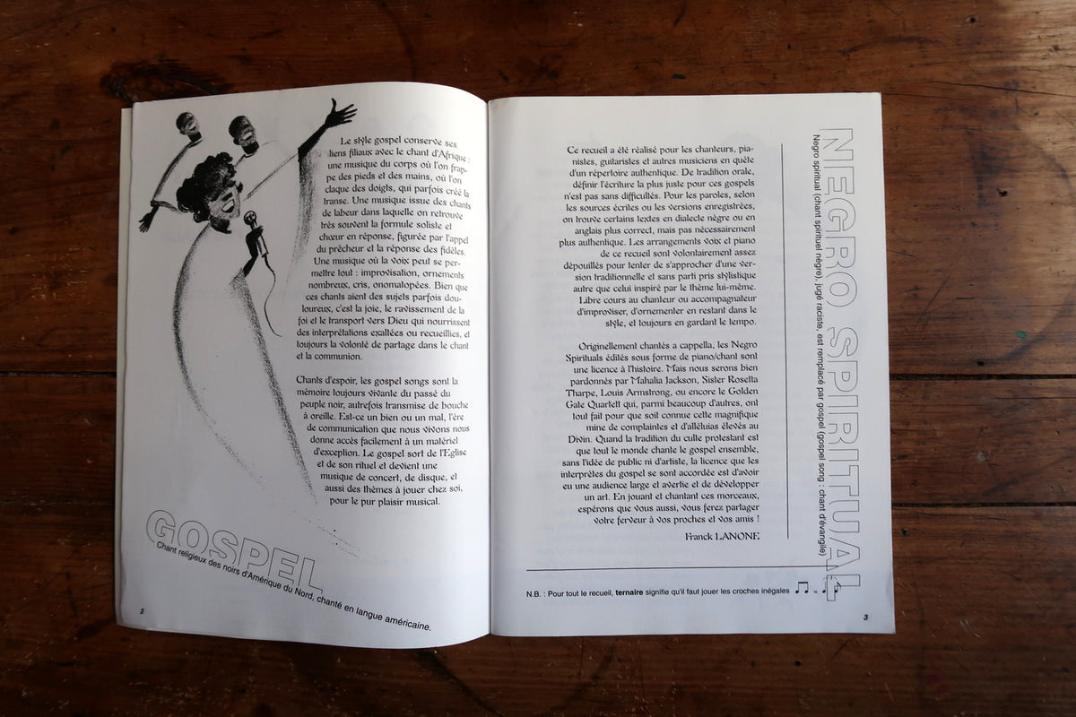 Low-angle view of the open music book showing curved pages and the bound spine.