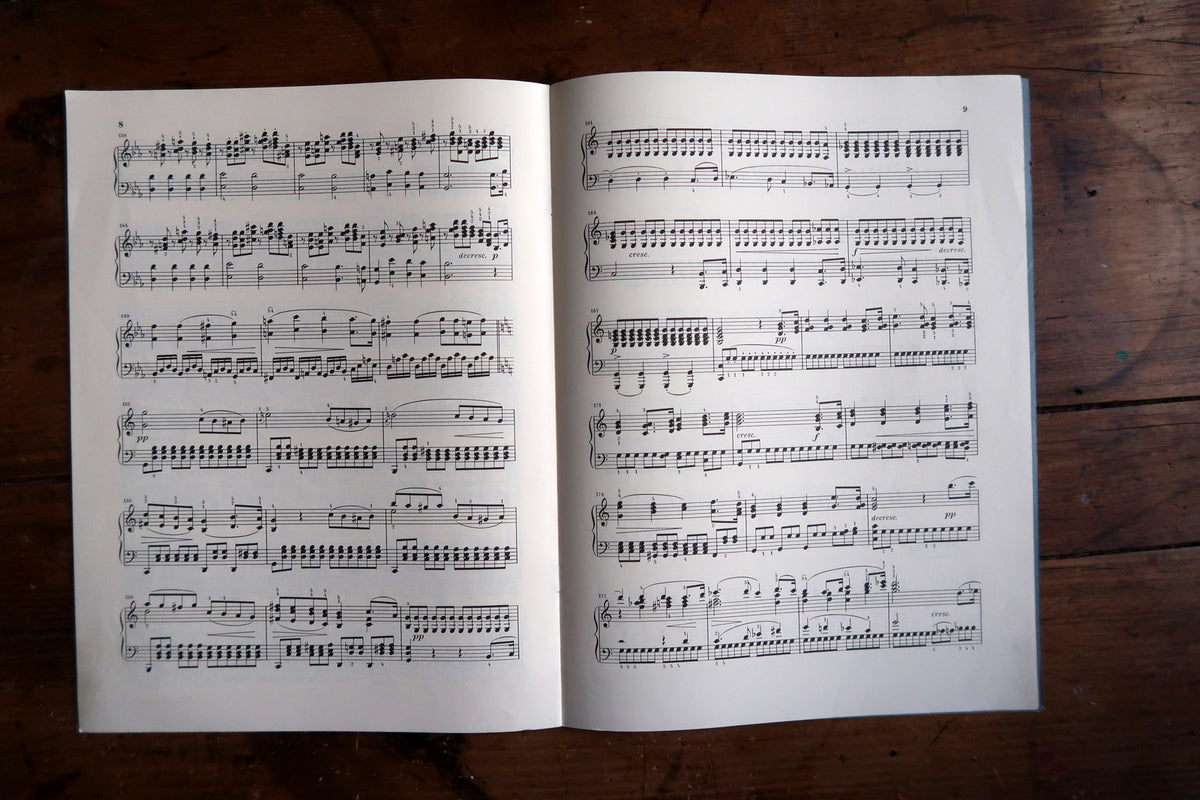 Interior piano-score pages numbered eight and nine with fingering and performance markings.