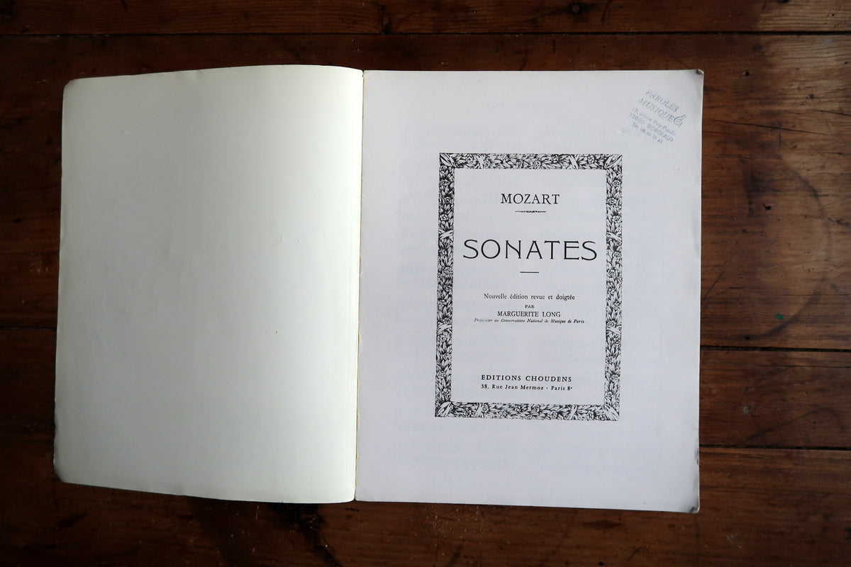 Low-angle view showing the thick page block, worn cover and dark spine reinforcement.
