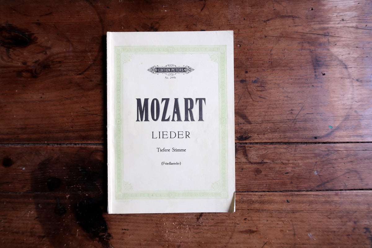 Low-angle open music volume showing piano staves, printed lyrics and the Edition Peters imprint.