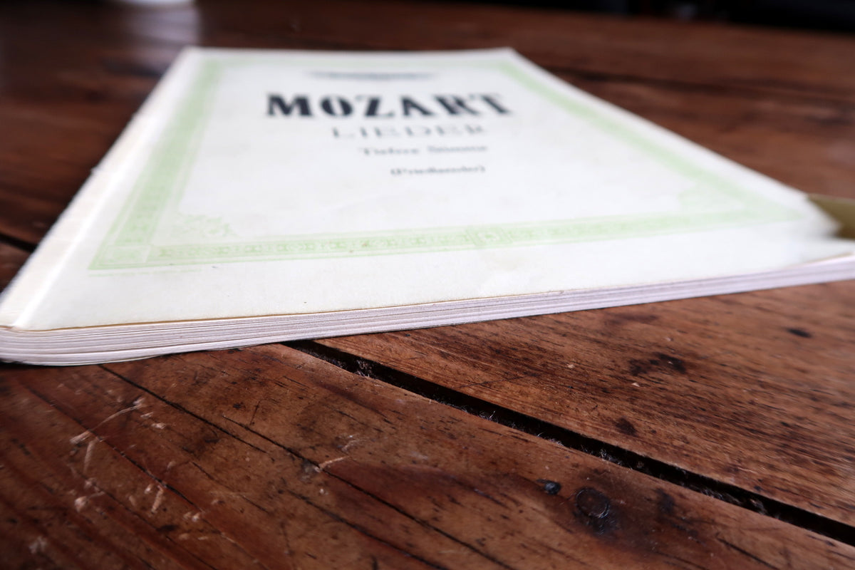 Full white Mozart Lieder front cover with pale green decorative border and Friedlaender credit.