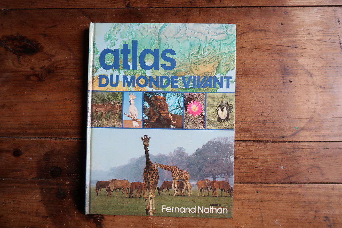 Fernand Nathan Atlas du monde vivant front cover with blue lettering, relief map and wildlife photographs.
