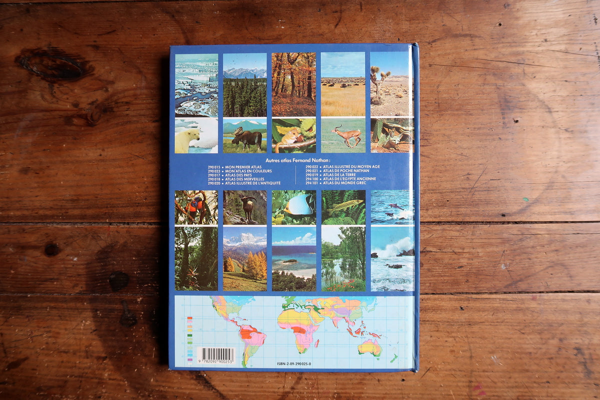 Open Indonesian archipelago spread with regional maps, lake photograph and tropical wildlife illustrations.