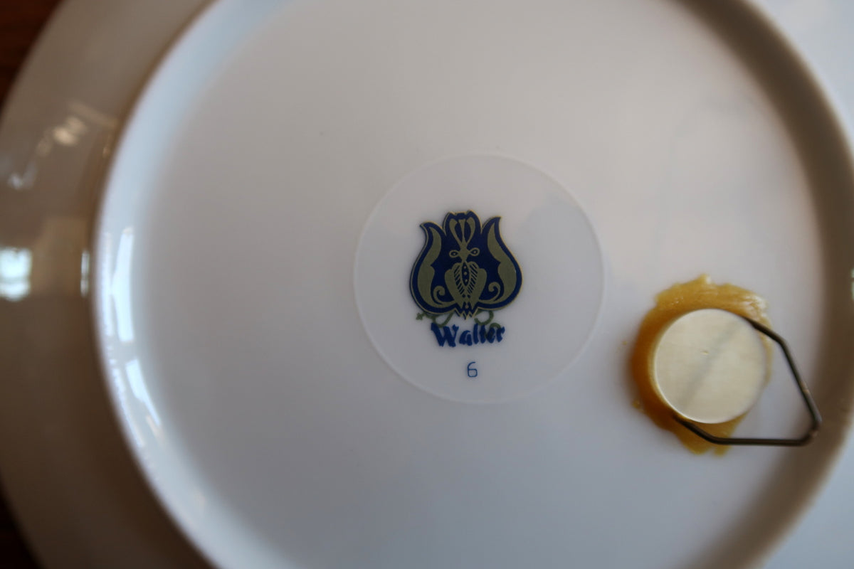 Close-up of blue Walther tulip backstamp, number 6 and circular adhesive wall-hanging mount.
