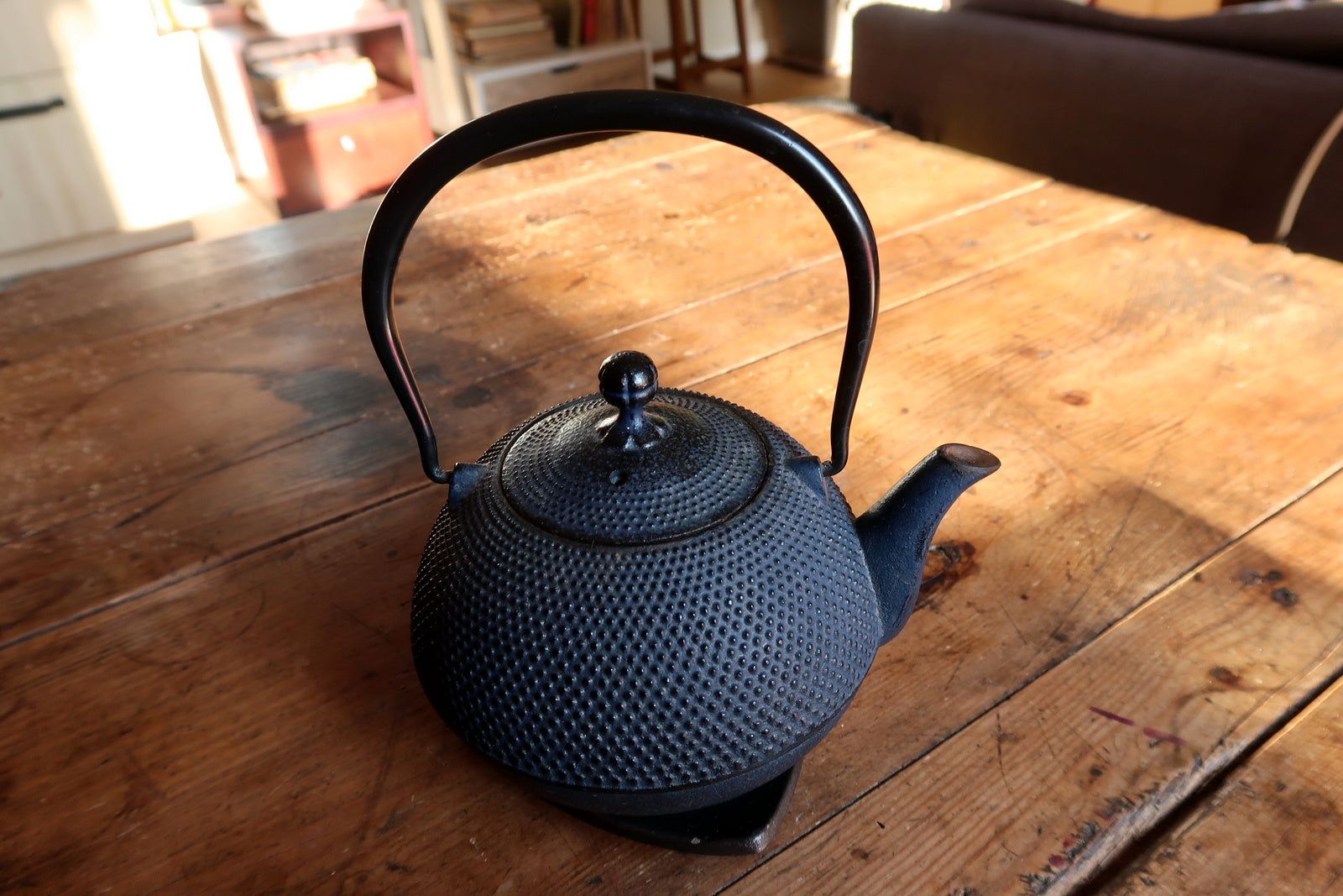 Vintage iron teapot detail, textured hobnail surface and aged patina