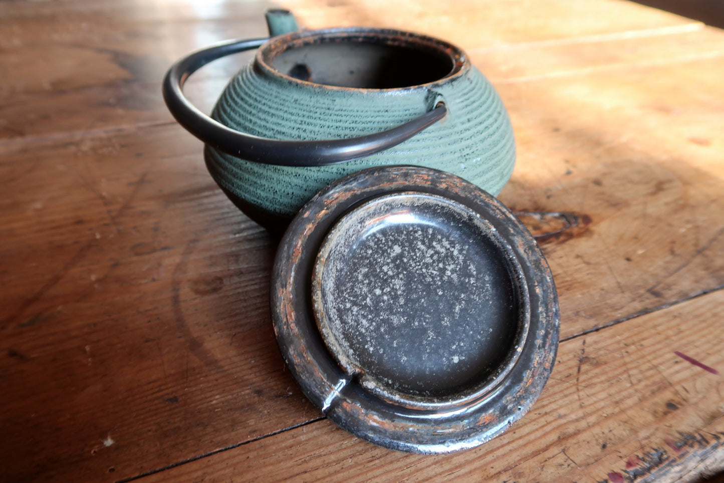 Tetsubin style teapot detail, green enamel surface and craftsmanship