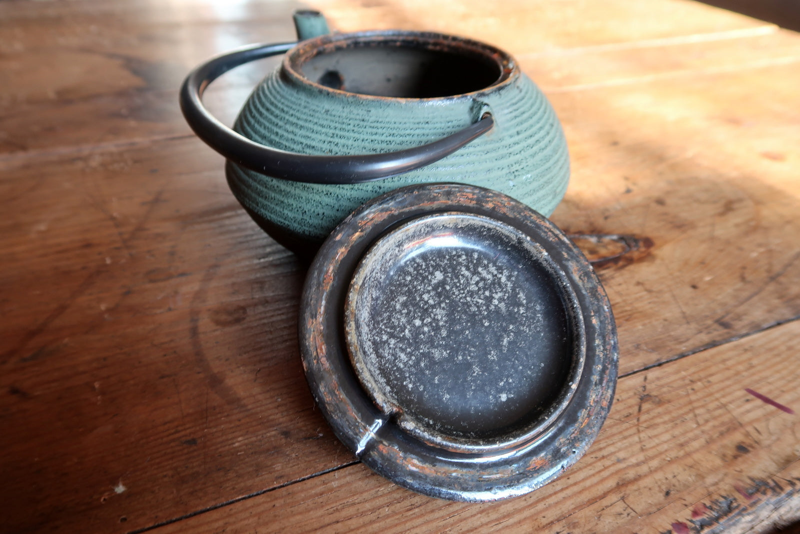Tetsubin style teapot detail, green enamel surface and craftsmanship