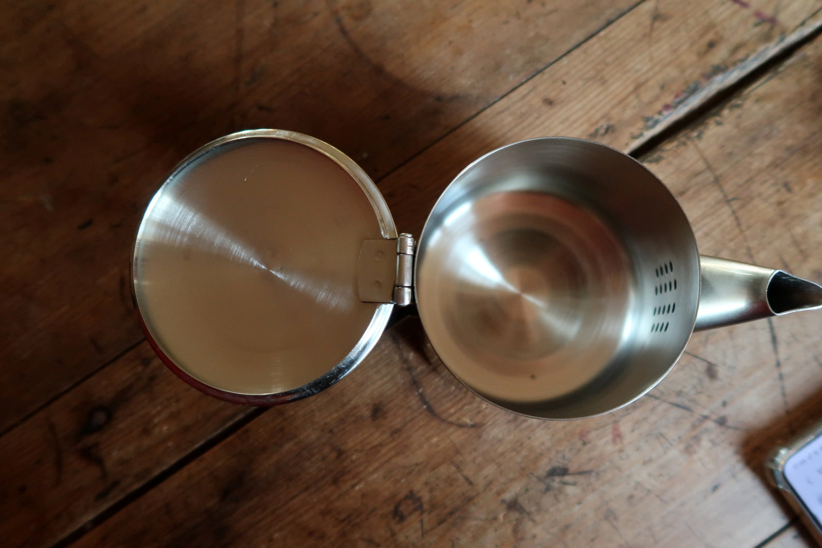 Stainless steel teapot detail, showing polished surface and modern lines
