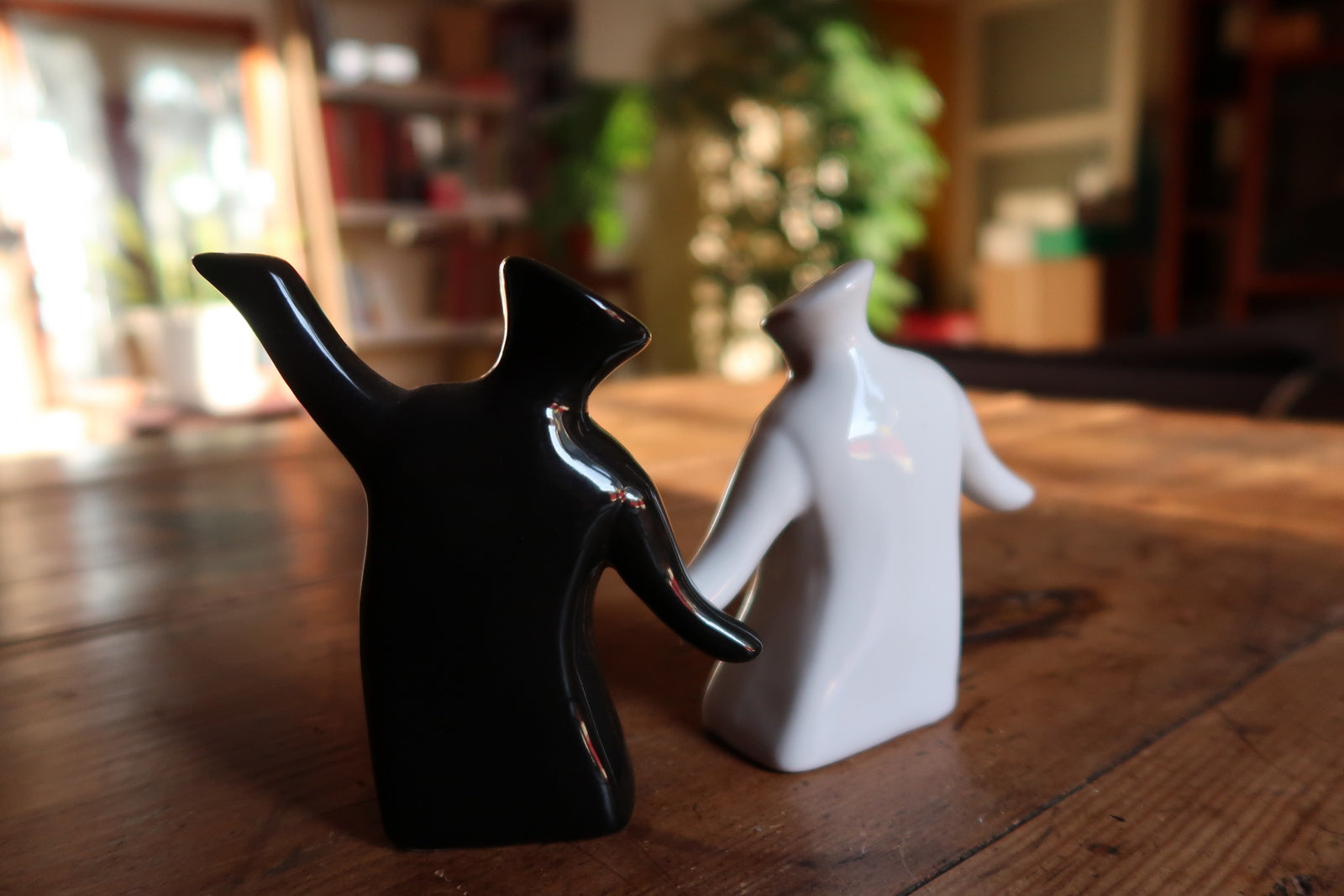 Minimalist salt and pepper shakers, black and white ceramic with human-like form