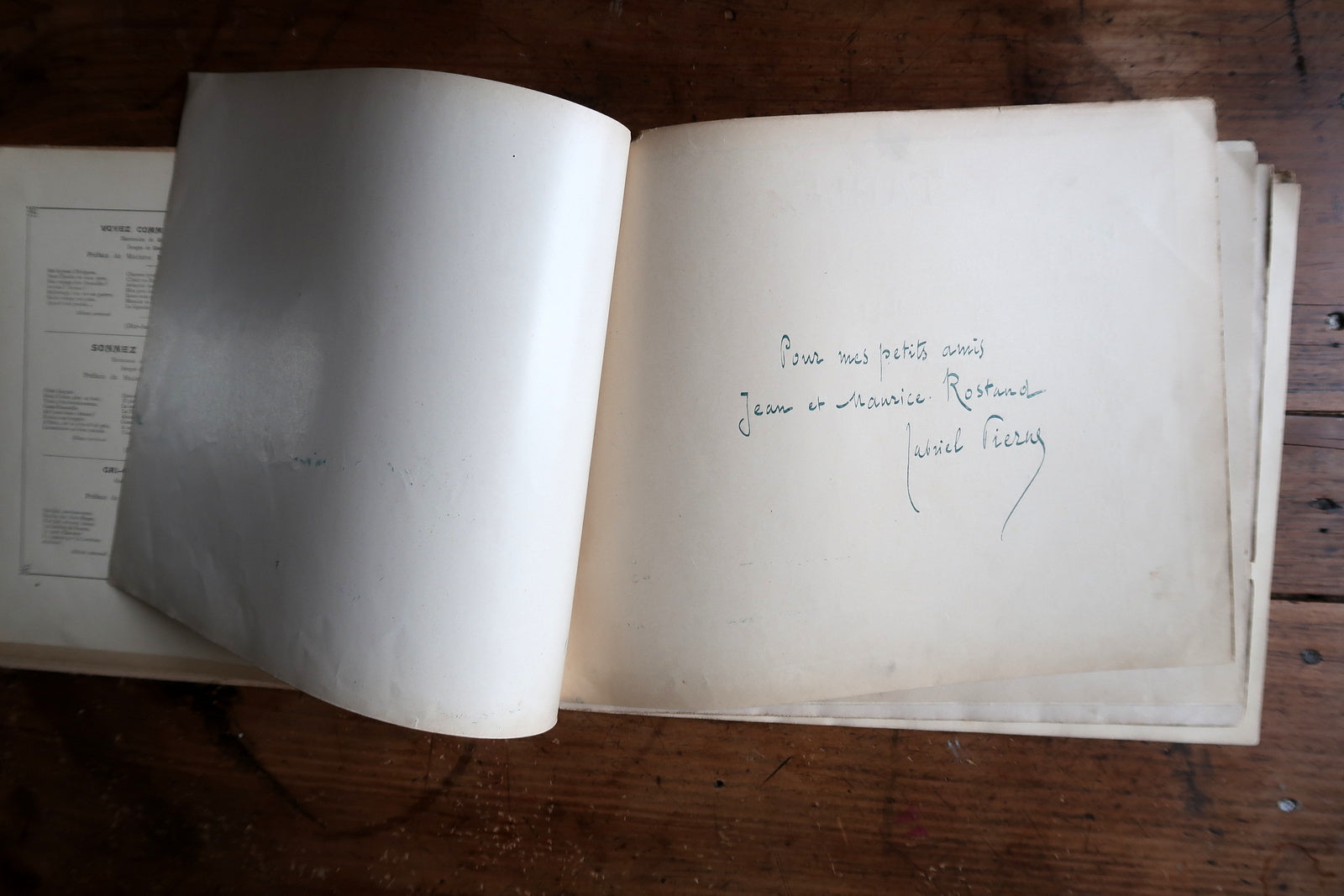 Antique illustrated songbook interior pages, musical scores and drawings