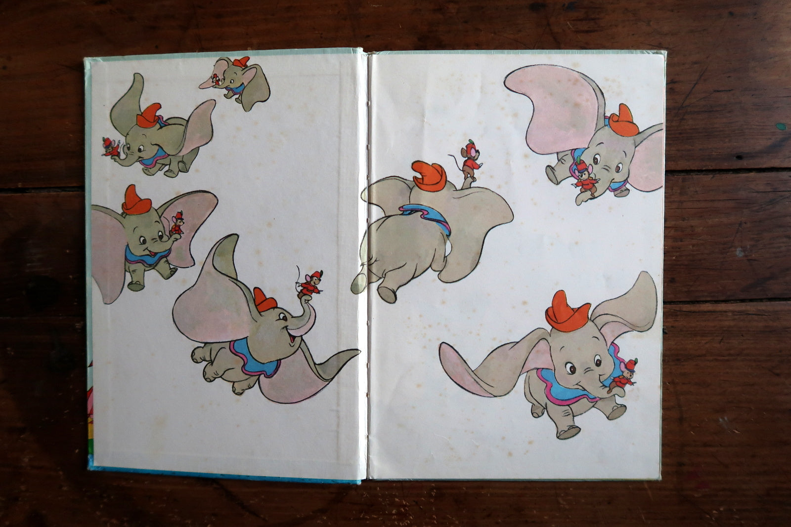 Vintage Disney book detail, Dumbo flying elephant scene with circus theme