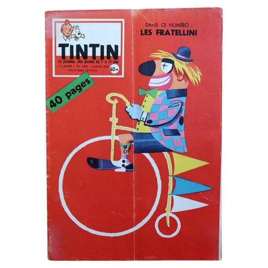 Vintage Tintin magazine No. 558 from July 1959, French comic journal featuring a striking circus-themed cover with a stylized clown riding a penny-farthing bicycle on a bold red background.

