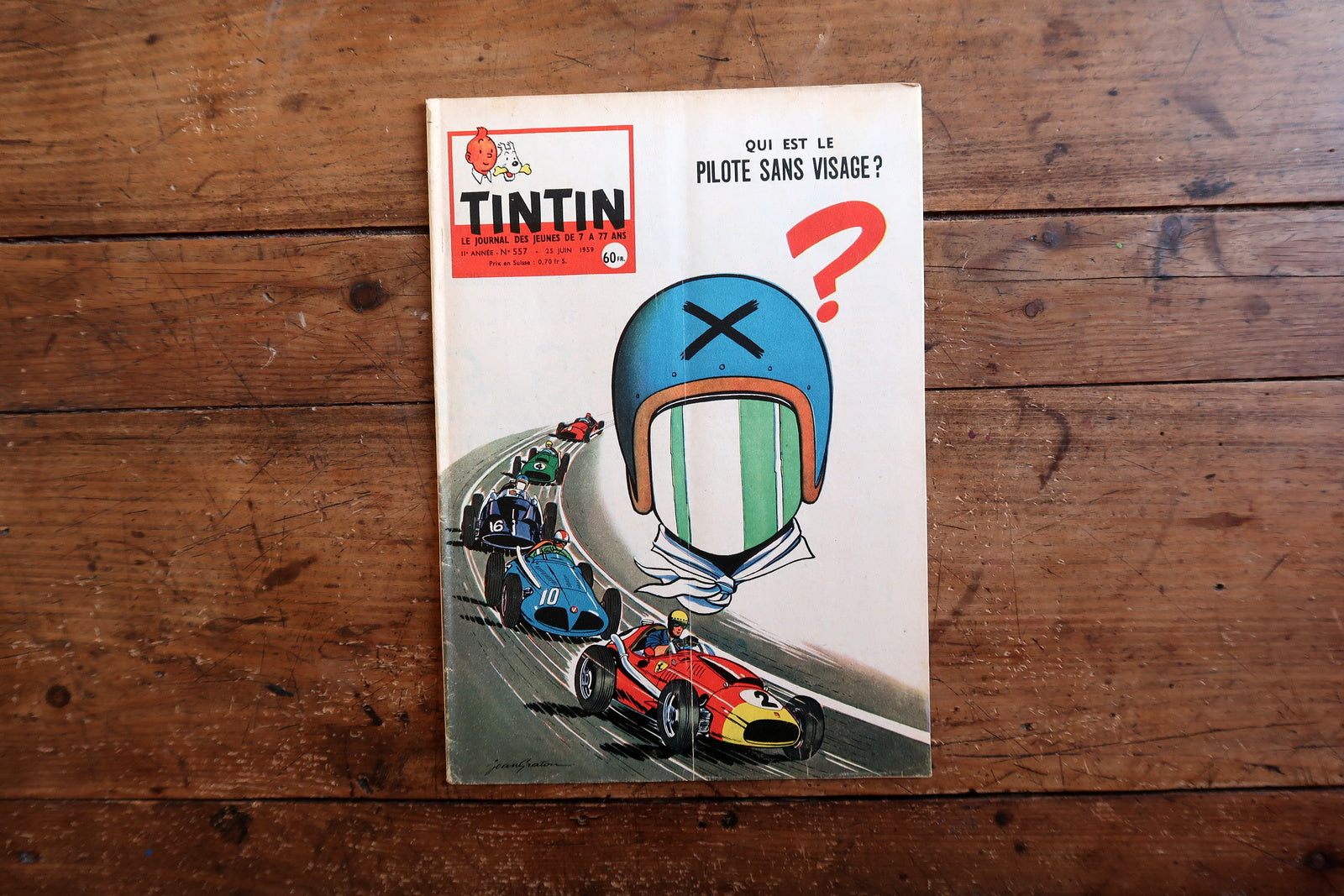 Vintage June 1959 Tintin magazine issue No. 557 displayed flat, measuring approximately 10.6 x 7.9 inches, with French language text and bande dessinée artwork.

