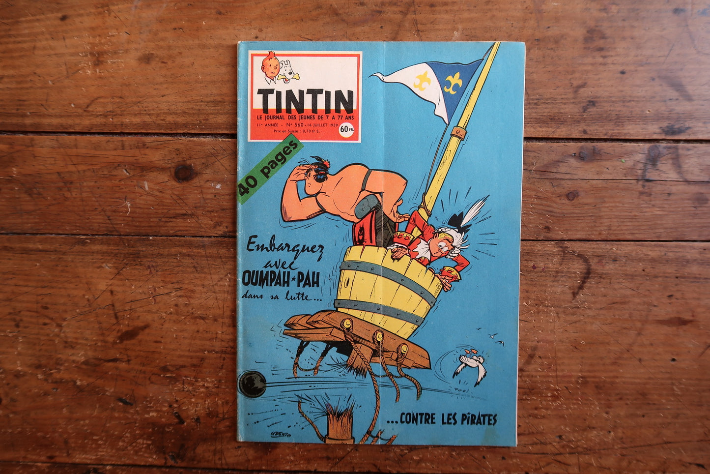 Vintage July 1959 Tintin magazine issue No. 560 displayed flat, measuring approximately 10.6 x 7.9 inches, with French language text and bande dessinée artwork.

