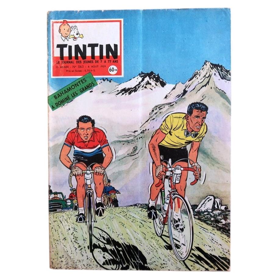 Front cover of vintage Tintin magazine No. 563 from August 1959 featuring a dynamic cycling-themed illustration of two racing cyclists climbing a mountain pass, evoking the Tour de France era.


