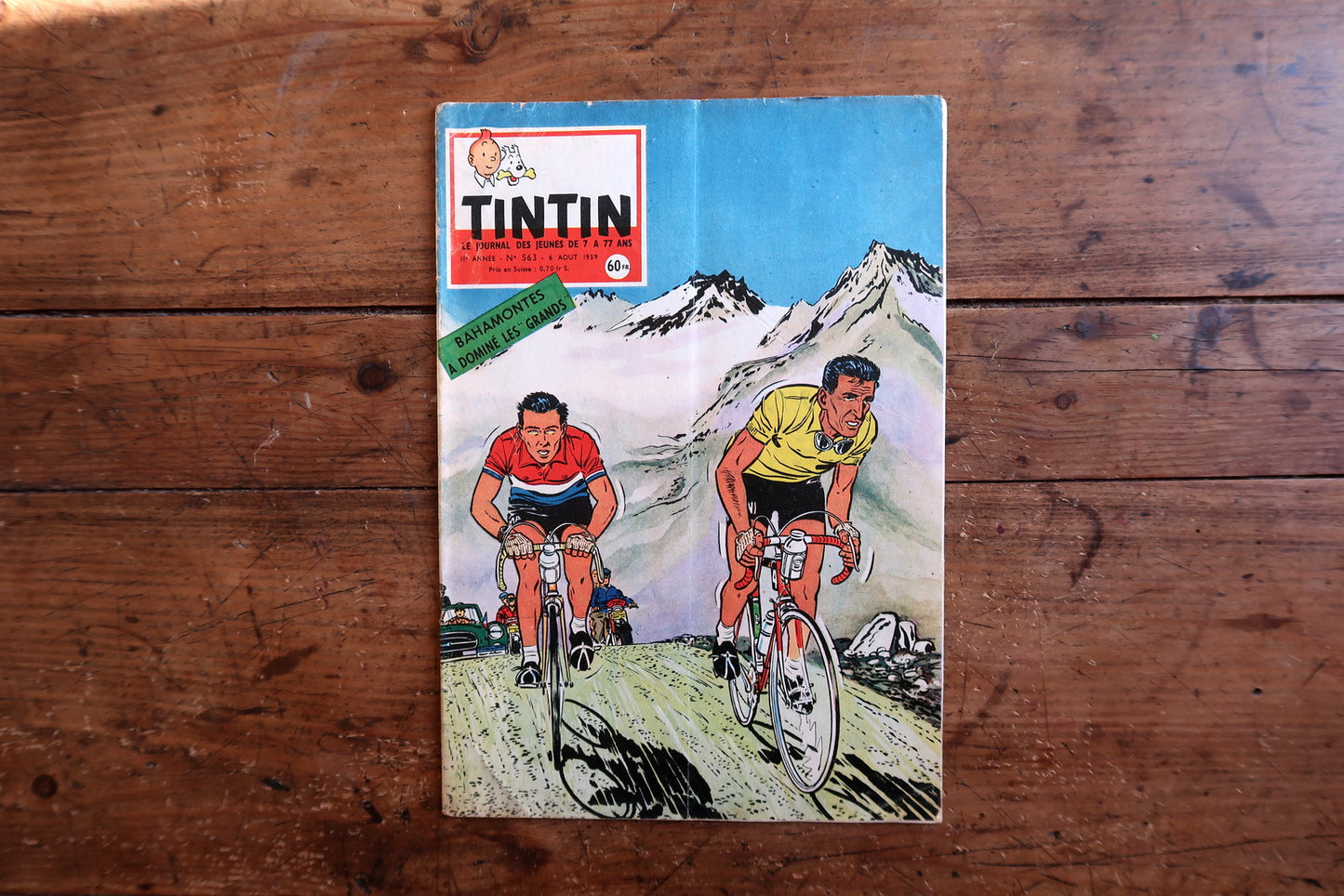 Vintage August 1959 Tintin magazine issue No. 563 displayed flat, measuring approximately 10.6 x 7.9 inches, with French language text and bande dessinée artwork.

