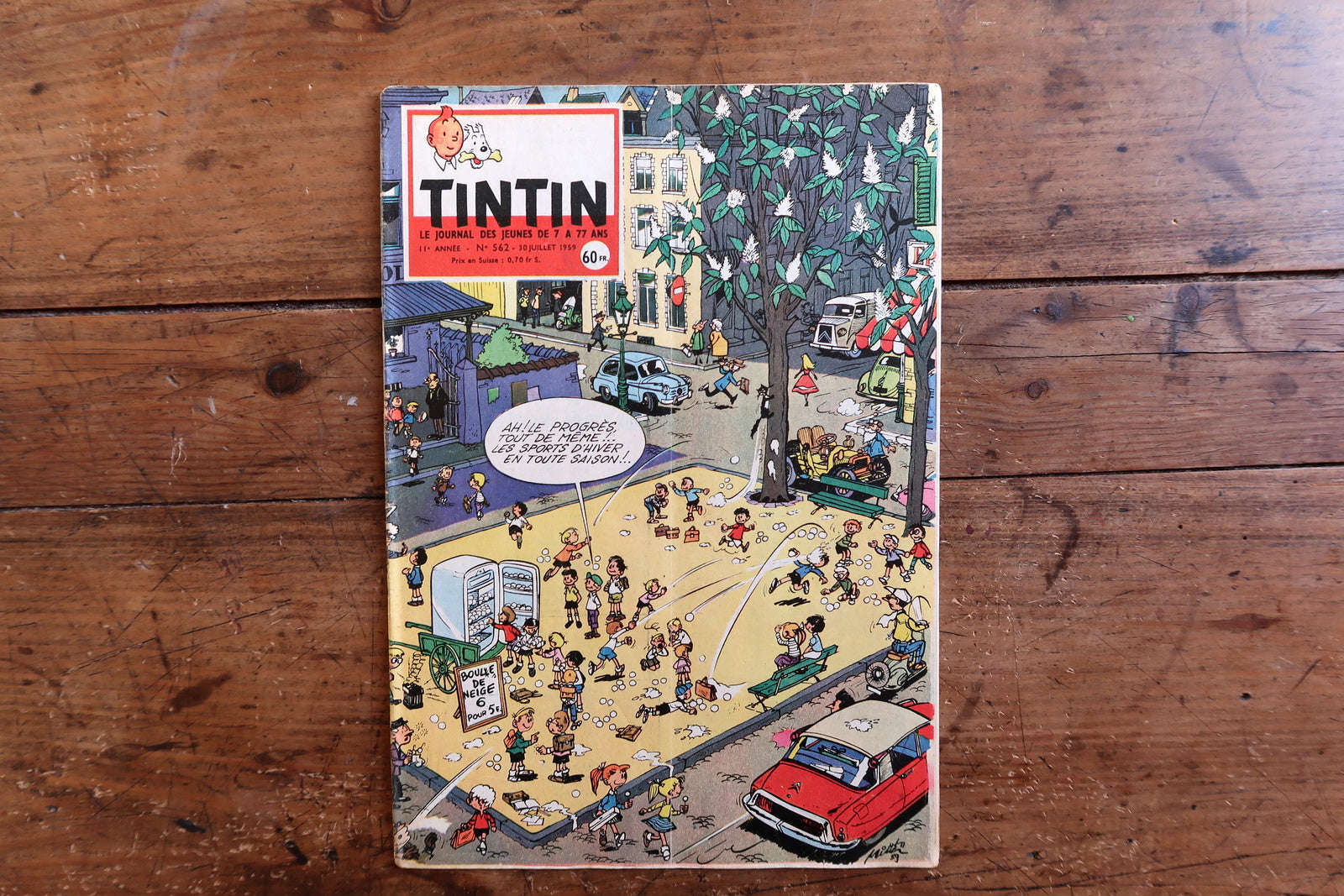 Vintage July 30, 1959 Tintin magazine issue No. 562 displayed flat, measuring approximately 8.3 x 11.8 inches, with French language text and bande dessinée artwork.


