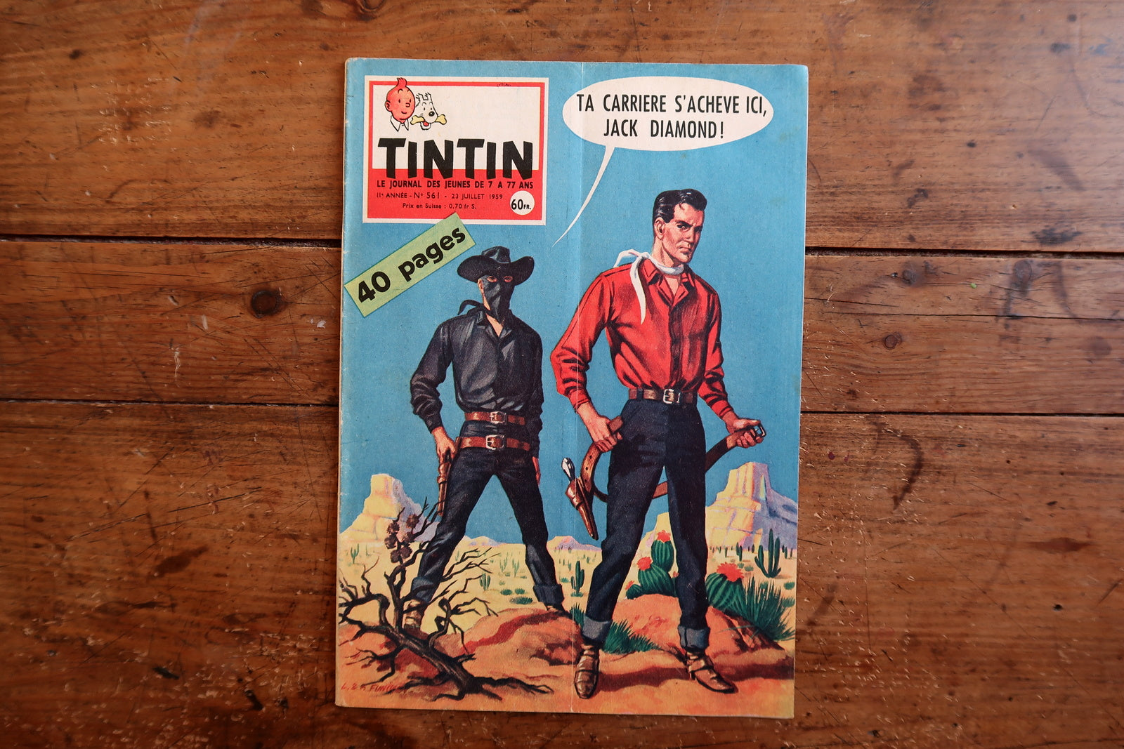 Vintage July 23, 1959 Tintin magazine issue No. 561 displayed flat, measuring approximately 8.3 x 11.8 inches, with French language text and bande dessinée artwork.

