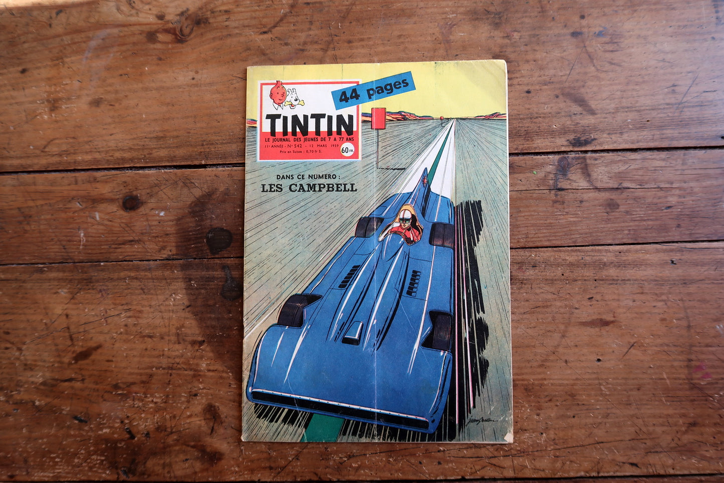 Vintage March 12, 1959 Tintin magazine issue No. 542 displayed flat, measuring approximately 8.3 x 11.8 inches, with French language text and bande dessinée artwork.

