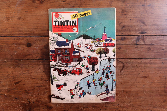 Close-up of the cover art on a 1959 French Tintin comic book magazine showing a snowy village scene with children sledding and skating, with the issue number and date.


